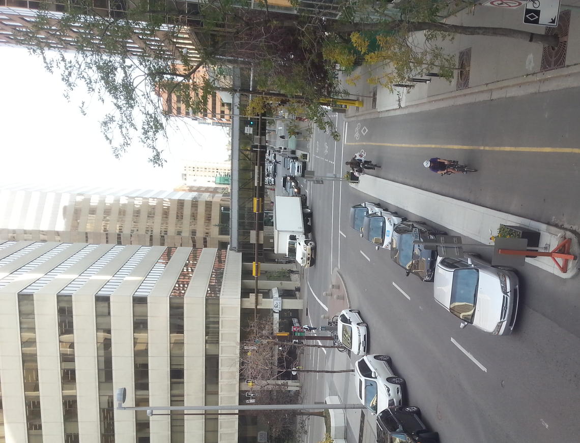 Cyclists and vehicles share the downtown streets through formal bike-paths.